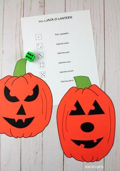 two pumpkins cut out to look like jack - o - lanternes on a piece of paper