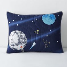 a pillow with an image of the moon and stars on it