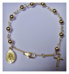 I make my own rosary by myself.  This is hand-weaved rosary bracelet with solid gold wire.   All parts(chain, clasp,crucifix, miraculous medal)  are 14k/18k solid gold.    This is custom-made only not ready-made.   For the delivery, I will use express tracking parcel of EMS.     * Metal : 14k/18k solid gold(hall-marked)   * Gold weight:   about 5.3- 5.5 gram(14k), about 6.5 - 6.8 gram(18k gold) * Gold Ball: 5mm * Length: 7,7.5, 8 inch *  Gold Miraculous medal: 9x 11mm,  * Gold Crucifix:10x 8mm * Finishing :Polished  * Authorized Gem certification will be provided    Ø Customs & Duties We are not responsible for any applicable customs charge, taxes and duties. Gold Rosary Bracelet With Cross And 8mm Beads, Dainty Handmade Gold Rosary Bracelet, Gold Handmade Cross Rosary Bracelet, Adjustable Gold Rosary Bracelet With Miraculous Medal, Gold Bracelets With Round Beads For First Communion, Gold Spiritual Rosary Bracelet For First Communion, Spiritual Gold Rosary Bracelet For First Communion, Gold Rosary Bracelet With 8mm Beads, Handmade Gold Bracelets For First Communion