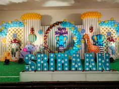 an elephant themed birthday party with balloons and decorations on the stage for children's birthday