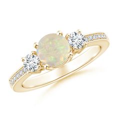 an opal and diamond three stone ring in yellow gold