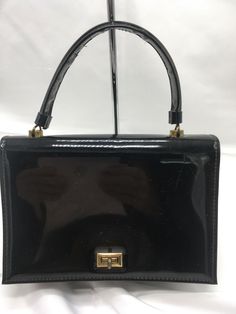 Vintage JR Florida Julius Resnick Black Patent Handbag Purse USA PLEASE READ FULL DESCRIPTION and VIEW ALL PHOTOS Some Wear, Scuffs, Scratches or Marks to Body Corners Edges Strap Brass Tone Hardware - Scratches, Wear Also Some Wear and Marks to Interior Wiped Clean No Odor Actual Measurements 9” Length 6” Height 4" Width 4.5” Carrying Handle Please Contact me before you Purchase if you have Question about Payment Please make Payment within 48 Hours close of Sale. Otherwise, item will be re-list Handbag Purse, Vintage Clothing, Carry On, Vintage Outfits, Top Handle Bag, Florida, Handbags, Closet, How To Wear