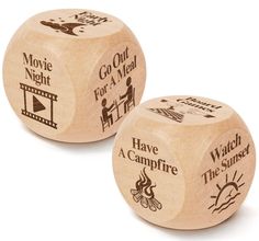 two wooden dices that say, go out for a meal and have a campfire