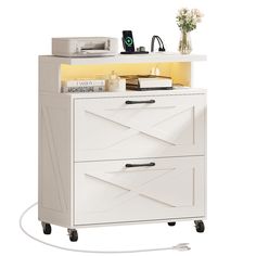 a white cabinet with two drawers and a printer on the top shelf next to it