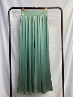 Silky SeafoamGreen Pants Like the smooth waves of the sea washing over the sand. Flow into the room with elegance in these silky mermaid-like pants. These pants are made with a silky, heavy fabric which creates a shimmery drape effect. The legs are flared and create a sleek look. The wide waistband is elastic and the fabric is also stretchy, for a flexible fit. Pleated at the front and the back. Model is 5'2" in 3-inch heels, wearing a size small. Stretch Satin Bottoms For Summer, High Waist Green Bottoms For Evening, Evening Green Trousers, Green Bottoms For Summer Evening Wear, Green Summer Evening Pants, Party Stretch Satin Bottoms, Summer Evening Green Bottoms, Stretch Satin Bottoms For Night Out, Green Evening Pants For Summer