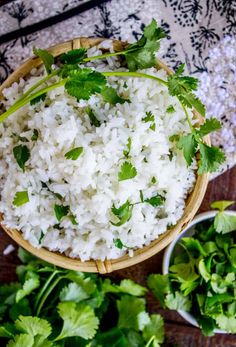 white rice with cilantro and parsley in a wooden bowl on a table