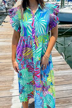 This multicolor printed dress features a collared neckline, smock detailed shoulders, frilled short sleeves, front button-up closure, side pockets, tiered, lined, and midi length. 50% Cotton 50% Rayon Hand Wash Cold. Do Not Wring Or Twist. Non Chlorine Bleach Only. Hang Dry. Low Iron As Needed. May Be Dry Cleaned. Madison is 5’8“ wearing a size Small.Model measurements:Bust: 32 in.Waist: 24 in.Hip: 34 In. Multicolor Ruffle Hem Maxi Dress For Summer, Summer Multicolor Ruffle Hem Maxi Dress, Multicolor Maxi Dress With Ruffle Hem For Summer, Summer Multicolor Maxi Dress With Ruffle Hem, Summer Multicolor Short Sleeve Midi Dress, Multicolor Short Sleeve Midi Dress For Summer, Patterned Short Sleeve Summer Maxi Dress, Summer Patterned Short Sleeve Midi Dress, Patterned Short Sleeve Maxi Dress For Summer