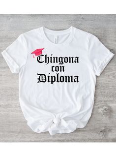 Where are all my LATINA graduates at? Felicidades! You are now a CHINGONA CON DIPLOMA! Everyone needs the perfect t-shirt to complement an everyday, laid-back look. The ideal top for so many occasions, this lightweight cotton tee will keep you comfy and looking smart. * 100% combed and ring-spun cotton  * Fabric weight: 4.2 oz/yd² (142 g/m²) * Pre-shrunk fabric * Side-seamed construction * Shoulder-to-shoulder taping * Blank product sourced from Guatemala, Nicaragua, Mexico, Honduras, or the US Funny Text Crew Neck T-shirt For College, Funny College T-shirt With Letter Print, Funny Letter Print T-shirt, Funny Pre-shrunk College T-shirt, Casual T-shirt With Text Print For Graduation, Funny Crew Neck T-shirt For College, Funny College Short Sleeve T-shirt, Funny Pre-shrunk Tops For College, Funny College T-shirt With Short Sleeves