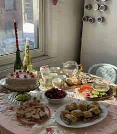 a table filled with food and wine bottles