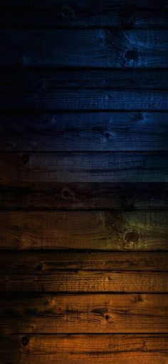 an image of wood planks that are painted in different colors and sizes with the light shining on them