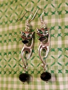 These delightful pierced earrings are the perfect retro look for the 50s lover in your life. Silver tone siamese cat with green jewels for eyes and black jewel for bow tie and your choice of green or black dangle. Total length around 2.5 inches Vintage Siamese Cat, Black Bowtie, Star Darlings, Eyes Black, Handmade Towel, Black Jewel, Square Photos, Dangly Earrings, Cat Earrings