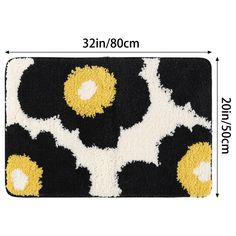 a black and white rug with yellow flowers on it, measurements for the area to be placed