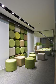 an office lobby with green and yellow furniture