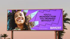 a billboard with a woman's face and words on the side that says you'll wonder how you worked without it