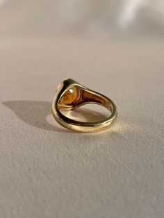 10k yellow gold signet ring by 23carat featuring a beautiful faceted citrine in a bezel setting. Excellent condition Size: 6.75 resizable* Weight: 5.7 grams Band: 11.0 mm (front), 3.0 mm (back) Citrine: 9.0 mm x 8.0 mm oval cut Hallmarks: 10k, water barrel and heart for 23carat Handmade to order, please allow for approximately 1 to 3 weeks before shipping For more details or customization options, emails us at info@shop23carat.com Formal Sapphire Ring With Bezel Setting And Oval Cabochon, Formal Yellow Gold Cabochon Sapphire Ring, Fine Jewelry Oval Cabochon Signet Ring For Formal Occasions, Fine Jewelry Oval Cabochon Signet Ring For Formal Wear, Timeless Signet Ring With Oval Cabochon Gemstone, Formal Fine Jewelry Signet Ring With Cabochon, Formal Cabochon Signet Ring, Classic Yellow Gold Sapphire Ring With Cabochon, Vintage Gold Signet Ring With Gemstone