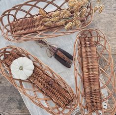 three wicker baskets sitting on top of a white table cloth next to each other