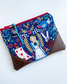 a small purse with an image of alice and wonderland on it