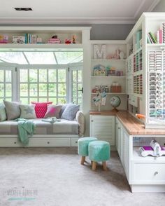 a living room filled with lots of furniture next to a window covered in bookshelves