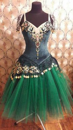 the dress is green and has gold trims on it, but not in color