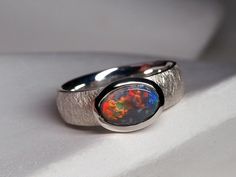 Silver ring with very bright natural genuine Black Opal opal origin - Australia opal measurements - 0.24 x 0.35 in / 6 x 9 mm opal weight - 0.72 carats ring size - 5.5 US ring weight - 4.93 grams ref No 11837 The ring comes with online gem certificate. Please note: full scale opalescence and different colors appears with different light and depends on point of view. Natural opal with inclusion and feathers. Please watch video under the daylight without Sun.     Worldwide shipping from Berlin, Ge Opal Silver Ring, Harry Potter Style, Large Ring, Ring Oval, Unisex Jewelry, Australian Opal, Boulder Opal, Natural Opal, Black Opal