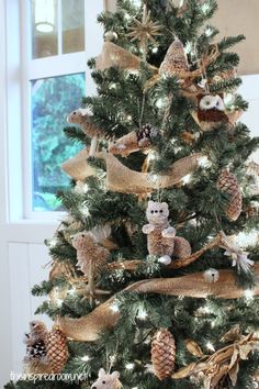 a christmas tree decorated with burlocks and pine cones