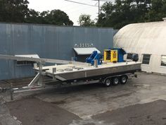 a boat trailer parked in front of a building