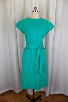 "Vintage Ultra Suede dress in a beautiful turquoise blue color. This dress is in excellent vintage condition. It has cap sleeves, matching belt, and to large pockets at the hips. There is no size tag, but I estimate it is approximately a contemporary womens size 8. Please refer to the following measurements when considering fit. Length 42\" Bust 34\" Waist 34\" Hips 42\" *Please note that vintage clothing and contemporary sizes can vary greatly. We take measurements of listed garments by laying Blue Fitted Belted Dress With Short Sleeves, Turquoise Blue Color, Suede Dress, Bleu Turquoise, Dress Clothes For Women, Turquoise Blue, Shirt Outfit, Size Tag, Vintage Clothing