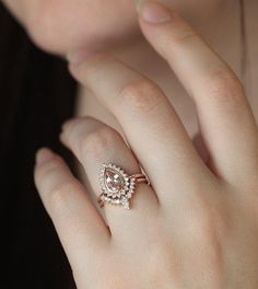 a close up of a person's hand with a ring on their finger and an earring