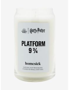 a white candle with harry potter's logo on the front and bottom, that says platform