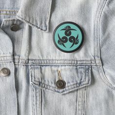 a blue and black sticker on the back of a jean jacket with an image of a snake