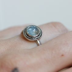 Playful and fun new western-style ring in Gorgeous Aquamarine and sterling silver. This is a perfect dainty southwestern ring with a twist - a double twist that is! Two .925 Sterling Silver graduated twist wires accent a 6mm Aquamarine cabochon. High-grade Blue Aquamarine with a perfectly detailed, sterling silver setting. Super cute blue aquamarine ring!! Set in .925 sterling silver -- oxidized and burnished bezel and wire. Simple, elegant, and perfect. This lovely little ring is created using Aquamarine Sterling Silver Rings, Heirloom Silver Aquamarine Rings, Silver Aquamarine Birthstone Ring, Oval Shape, Blue Sterling Silver Crystal Ring, Stamped 925, Silversmith Rings, Silver-tone Aquamarine Diamond Ring For Gift, Blue Aquamarine Ring, Tourmaline Bracelet, Crazy Lace Agate