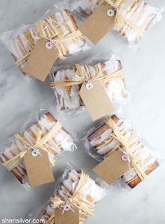 small pastries wrapped in plastic and tied with twine on white marble counter top