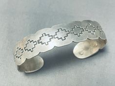 "MAKE US AN OFFER BY CLICKING THE \"MESSAGE SELLER\" Button- This is a traditional vintage Navajo bracelet! It features a scalloped-edge solid silver cuff with handcarved silver rug designs across it! Truly Lovely! The width of the bracelet measures around 1/2\". Signed by Navajo artist, F. James. Sterling silver. The inside end to end measures around 6\" with an additional 1-1/4\" gap. Sturdy 21 grams. Make Us an Offer- Due to the high demand of our items, many pieces sell quite fast. The most Southwestern Style Adjustable Etched Bracelets, 21 Grams, Navajo Bracelet, Rug Designs, Silver Rug, Bluish Green, Vintage Navajo, Sterling Silver Bracelet, Silver Cuff