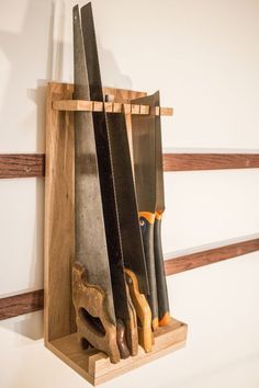 several knives are in a wooden holder on the wall