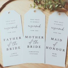 three white tags with the words, mother of the bride and groom printed on them