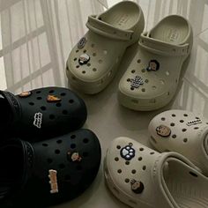 several pairs of crocs are lined up on the floor next to each other