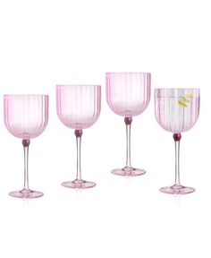 four pink wine glasses sitting next to each other