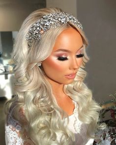 a woman with long blonde hair wearing a tiara