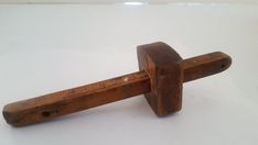 an old wooden handle on a white surface