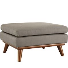 the footstool is made out of wood and has a gray fabric cushion on it