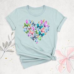 "Butterfly Spring Shirt, Mothers Day Gift, Butterfly Heart Shirt, Moth T-Shirt, Women Aesthetic Shirt, Summer T-Shirt, Butterfly Lovers Shirt Hello, Thanks for your support. Your gladness comes first and all work is done with Love in here. Always keep your support, please:) Butterfly Spring Shirts are branded Bella+Canvas.  Butterfly Spring Shirt  Contents: - Solid colors: %100 Cotton.  - Heather colors: %52 Cotton + %48 Polyester* This ultra-soft graphic tee is made from a comfortable cotton-poly blend that is breathable, non-shrinking, and lasts longer than your average graphic shirt. HOW TO ORDER YOUR BUTTERFLY SPRING SHIRT  -Please, Check and Review all  Butterfly Spring Shirt Photos. -Select Your Butterfly Spring Shirt T-Shirt Size and Butterfly Spring Shirt T-Shirt Color from drop-do Cute Butterfly Print Crew Neck T-shirt, Mother's Day Heart Print Short Sleeve T-shirt, Short Sleeve T-shirt With Heart Print For Mother's Day, Mother's Day Short Sleeve T-shirt With Heart Print, Cute Butterfly Print Short Sleeve T-shirt, Cute Short Sleeve T-shirt With Butterfly Print, Blue Top With Butterfly Print And Crew Neck, Blue Crew Neck Top With Butterfly Print, Blue Butterfly Print Short Sleeve T-shirt