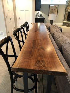 a long wooden table sitting in the middle of a living room