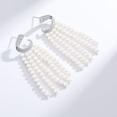 Transform your look with our Luxurious Curved Cubic Zirconia & Multi-Chain Pearl Earrings, a sophisticated blend of sparkle and elegance. The design features a gracefully curved band of brilliant cubic zirconia at the top, leading to five delicate chains adorned with lustrous 3-4mm freshwater pearls. Crafted meticulously in sterling silver, these earrings exude opulence and charm, making them a striking accessory for luxury events or whenever you desire to infuse a touch of glamour into your att White Cubic Zirconia Crystal Earrings With Elegant Design, Elegant White Crystal Pearl Earrings, White Cubic Zirconia Chandelier Earrings For Formal Occasions, White Cubic Zirconia Chandelier Earrings For Formal Events, Elegant Pearl Earrings With Cubic Zirconia, Elegant Bridal Earrings In Diamond White Cubic Zirconia, Formal White Cubic Zirconia Chandelier Earrings, Elegant Diamond White Pearl Earrings For Party, Elegant Crystal Pearl Earrings For Pierced Ears