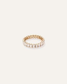 a gold ring with pearls on it