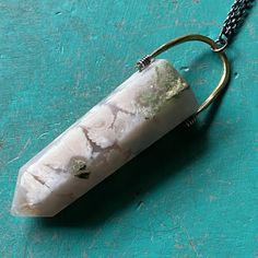 I recently sourced some beautiful crystals and stones so that we could make some more unique Taliswoman necklaces!This listing is for a lovely Cherry Blossom Agate, measuring 2 1/8" tall and 3/4" wide at the top of the stone, suspended from a brass bail with a 20" Sterling Silver chain. Cherry Blossom Agate is the stone of dreamers! If you are a person who is goal driven and has high hopes from life, then a Cherry Blossom Agate will keep you striving after them constantly! The rock is known to n Agate Necklaces With Natural Inclusions For Healing, Unique Quartz Crystal Necklace With Gemstone, Unique Moss Agate Necklace For Healing, Unique Mineral Crystal Pendant, Healing Moss Agate Crystal Necklace With Natural Stones, Large Stone Pendant Crystal Necklace, Unique Quartz Crystal Necklaces With Natural Stones, Bohemian Pendant Crystal Necklaces With Large Stone, Bohemian Crystal Pendant Necklace With Large Stone