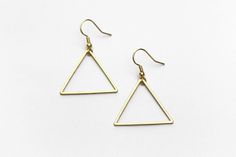 "Lightweight, geometric triangle earrings perfect for your next day out in the summer sunshine. ▲ Brass triangles measure approx. 1 1/4\" ▲ Gold-plated surgical steel earring hooks (hypoallergenic) We try to display product colors as close to life as possible. However, all monitors are different and so there might be slight color variations from screen to screen. CARE INSTRUCTIONS Jewelry should be kept away from moisture as much as possible. Remember to take your jewelry off before swimming and Minimalist Triangle Nickel-free Earrings, Minimalist Nickel-free Triangle Earrings, Minimalist Earrings For Summer, Minimalist Metal Earrings For Summer, Minimalist Triangle Earrings For Everyday, Minimalist Summer Earrings With Ear Wire, Triangle Shaped Earrings For Summer Gift, Triangle Shaped Summer Earrings For Gifts, Triangle Shaped Summer Earrings For Gift