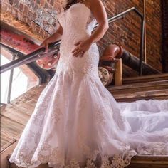 a woman in a wedding dress standing on some stairs