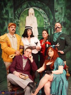 a group of people dressed in costumes posing for a photo