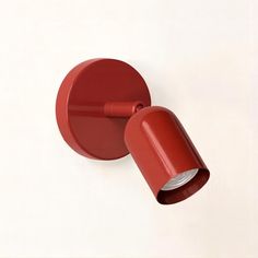 a red wall light on a white background