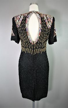 "Just for fun...this Laurence Kazar dress features beading and sequins on silk. It is circa 1980-90's and has a key-hole detail in the back. There is one small area of missing beads on the back hip area (picture) It is otherwise in very good vintage condition. Estimated size M 36\" bust 32\" waist 38\" hip 39\" shoulder to hem Purveyor's Note: We have searched far and wide, wrestled bears, braved the cold, traversed mountain ranges, fought pirates, swam with sharks and eaten at many a questionab Vintage Beaded Dresses For Party Season, Vintage Beaded Dresses For Night Out, Beaded Sequin Dress For Cocktail Parties, Holiday Cocktail Sequin Beaded Dress, Festive Beaded Sequin Dress For Night Out, Holiday Beaded Fitted Sequin Dress, Festive Beaded Sequin Dress For Cocktail, Festive Beaded Sequin Cocktail Dress, Dress Sparkle